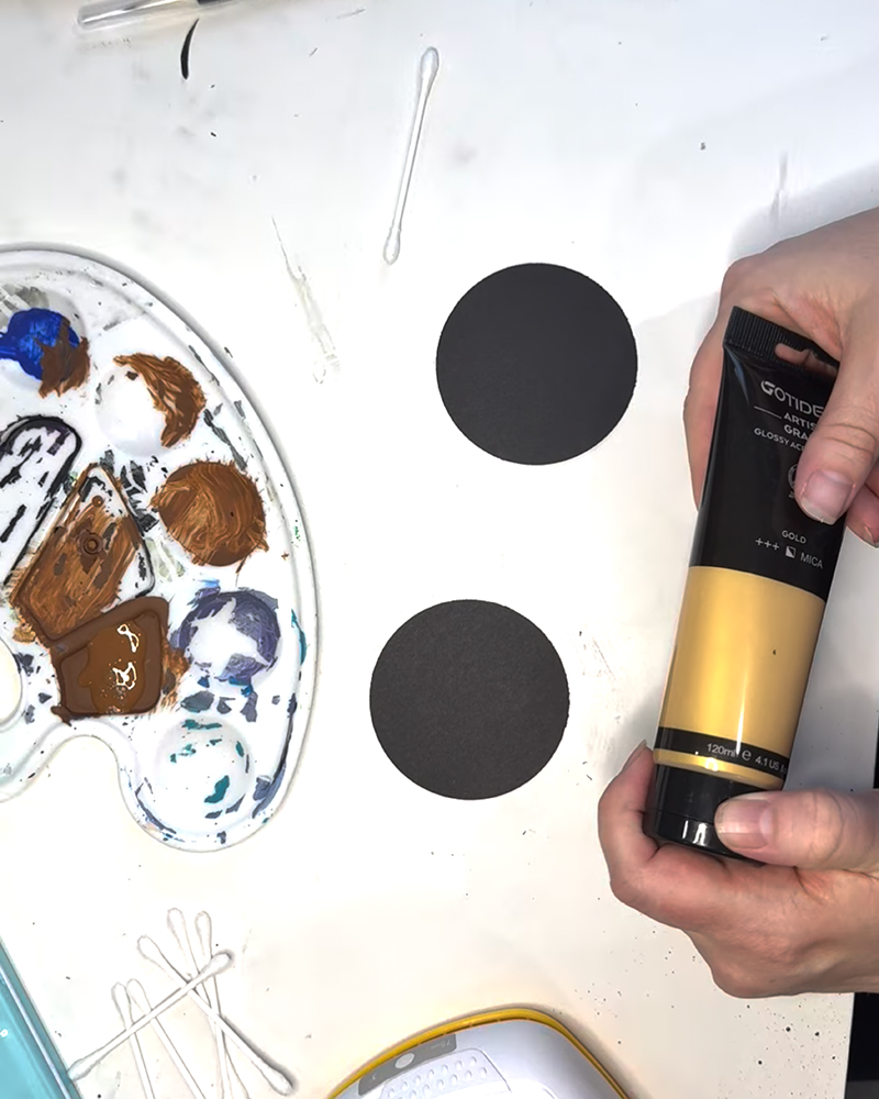 Gold acrylic paint for a mixed-media sunflower project.