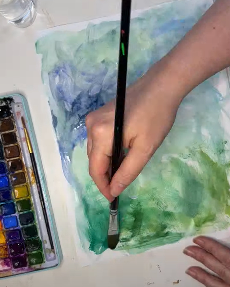 Painting a watercolor background for the sunflower art.